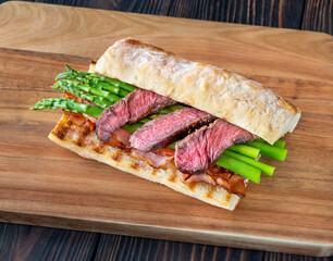 Sandwich with asparagus and slices of beef steak