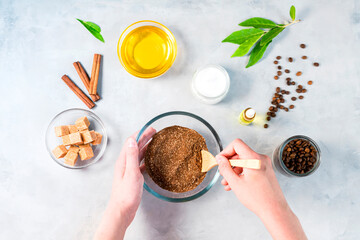 Woman mixing ingredients preparing coffee scrub or mask for skin treatment