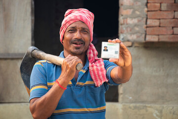Rural Indian Farmer Showing aadhar card
