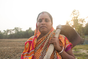 Indian Rural Woman  Farmer holding a Shovel - obrazy, fototapety, plakaty