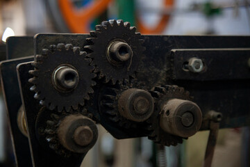 Gears on an old mechanical machine, Electro-mechanical assembly, closeup, interconnected cogs