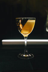 Golden cocktail in a decorated glass Alcohol luxury aesthetics