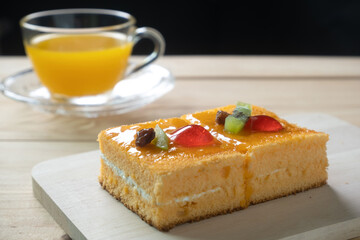 orange cake topped with orange jam.served with orange juice.