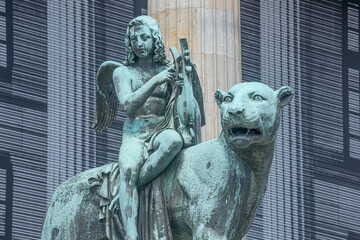 Statue of a panther with genius of music, an angel with wings and a harp, stringed musical...
