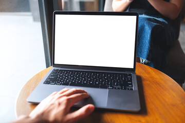 Mockup image of a man using and touching on laptop touchpad with blank white desktop screen