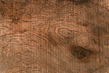 Obraz premium Ciemno brązowe drewniane tło, tekstura desek z pęknięciami.