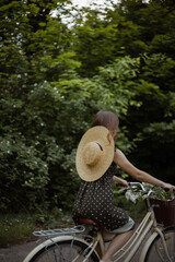 young girl riding a bicycle in the woods