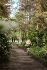 young girl riding a bicycle in the woods