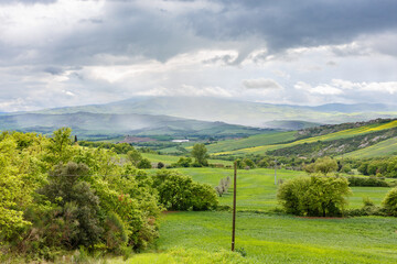 Rural valley with rain sheds on the horizon
