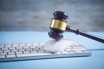 Judge gavel with a computer mouse and keyboard.
