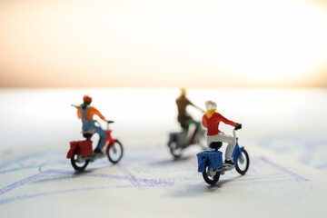 Miniature motorcycle / bigbike people riding passport book with copyspace, Travel around the world, explore the earth, adventure trip and travels insurance background Concept.