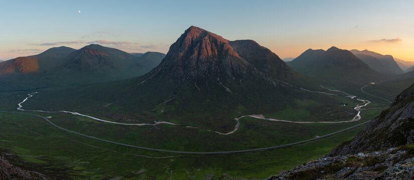 Breathtaking panoramic view of mountain peak with meandering river running through valley in the Scottish Highlands. Glencoe, UK.