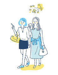 笑顔で歩く2人の女性