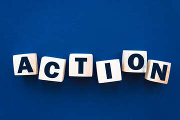 Wooden Blocks with the text: Action. Business and Education concept.
