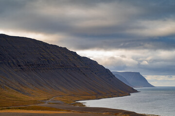 West Fjords or The Westfjords is region in north Iceland. Dramatic moody sky nature landscape