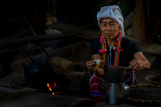 Hill tribe women drinking coffee. Ancient coffee brewing. Making Thai coffee and tea using coffee bag.