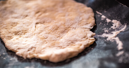 Close and selective focus on a home made Indian chapati flat bread on a baking sheet ready for cooking