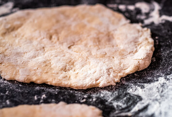Close and selective focus on a home made Indian chapati flat bread on a baking sheet ready for cooking