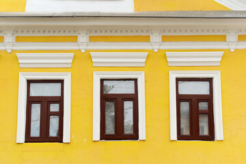 Fototapeta na wymiar The facade of an old house with wooden windows. Close-up. Flat lay frame