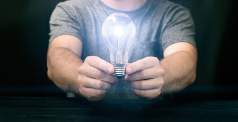Creative new idea. Innovation, brainstorming, inspiration and solution concepts. Man holding light...