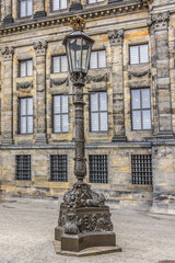 Fototapeta na wymiar Antique Lamp Post near Royal Palace (Koninklijk Paleis) at the Dam Square in Amsterdam, The Netherlands.