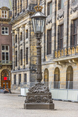 Antique Lamp Post near Royal Palace (Koninklijk Paleis) at the Dam Square in Amsterdam, The Netherlands.