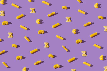 Flat lay pattern with different shapes of pasta. Minimal food composition. Creative macaroni pattern.