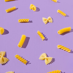 Unique composition with different shapes of pasta. Fun and bright food concept. Minimal pattern.