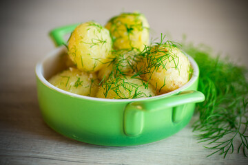 boiled early potatoes with butter and fresh dill in a bowl