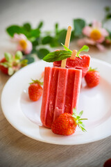 homemade strawberry ice cream on a stick made from fresh strawberries in a plate