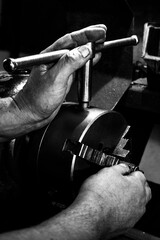 black and white image of the hands of a metalworker