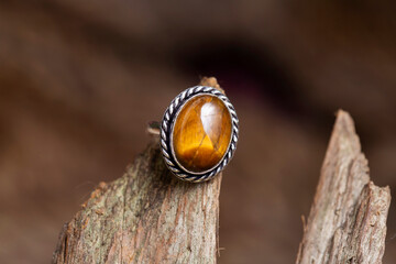 Brass metal tiger eye mineral stone ring on natural background - 441768193