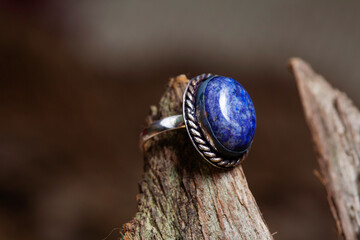 Brass metal lapis lazuli mineral stone ring on natural background