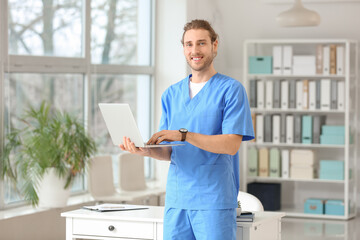 Young doctor using laptop in clinic