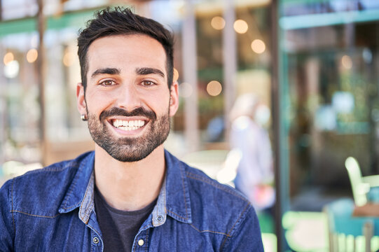 Smiling ethnic man with beard in restaurant