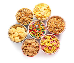 Bowls of different cereals on white background