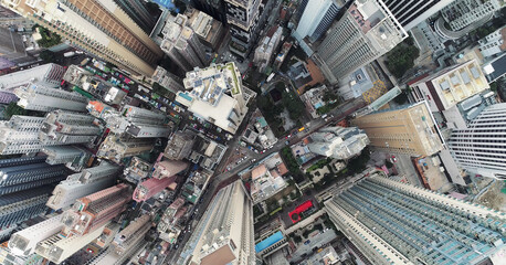 Top view aerial photo from flying drone of a developed Hong Kong city with modern skyscrapers with contemporary design. China town with business and financial centers and road with cars