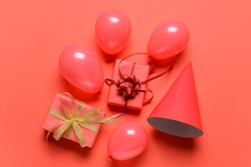 Gift boxes with balloons and party hat on color background