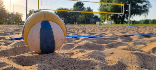 Beach volleyball court with a volleyball ball placed in the sand. - Powered by Adobe