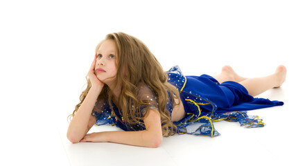 Fototapeta premium Blonde Girl in Oriental Costume Lying on the Floor Supporting He