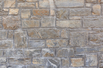 Fragment of a wall faced with stone tiles. Background for design.