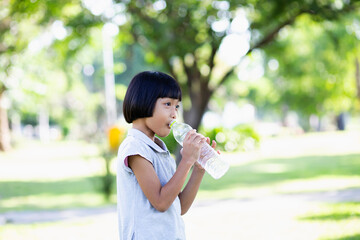 Lovely little girl drinking water