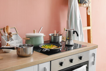 Fototapeta na wymiar Modern electric stove and utensils in kitchen