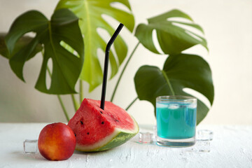 watermelon and blue curacao cocktail on the white board. Delicious cocktail drink with fresh fruits with peach and ice.