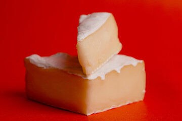 cheese with white mold close-up on a red background