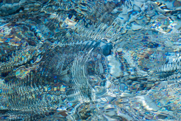 Magic blue caustics on the sea surface