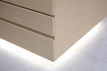 Corner on wooden cabinet with locker design for storage.
