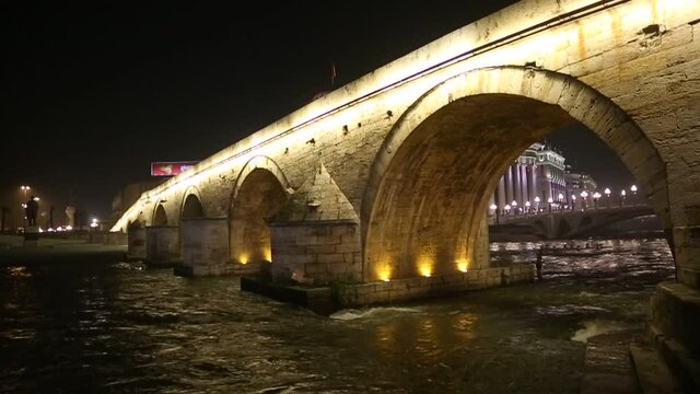 Stone Bridge at night in Skopje, Macedonia. Stone bridge is considered a symbol of Skopje.
