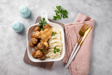  Traditional swedish meatballs with creamy sauce and mashed potatoes on gray background top view - obrazy, fototapety, plakaty