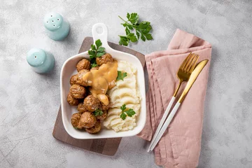 Foto op Aluminium  Traditional swedish meatballs with creamy sauce and mashed potatoes on gray background top view © Kseniya